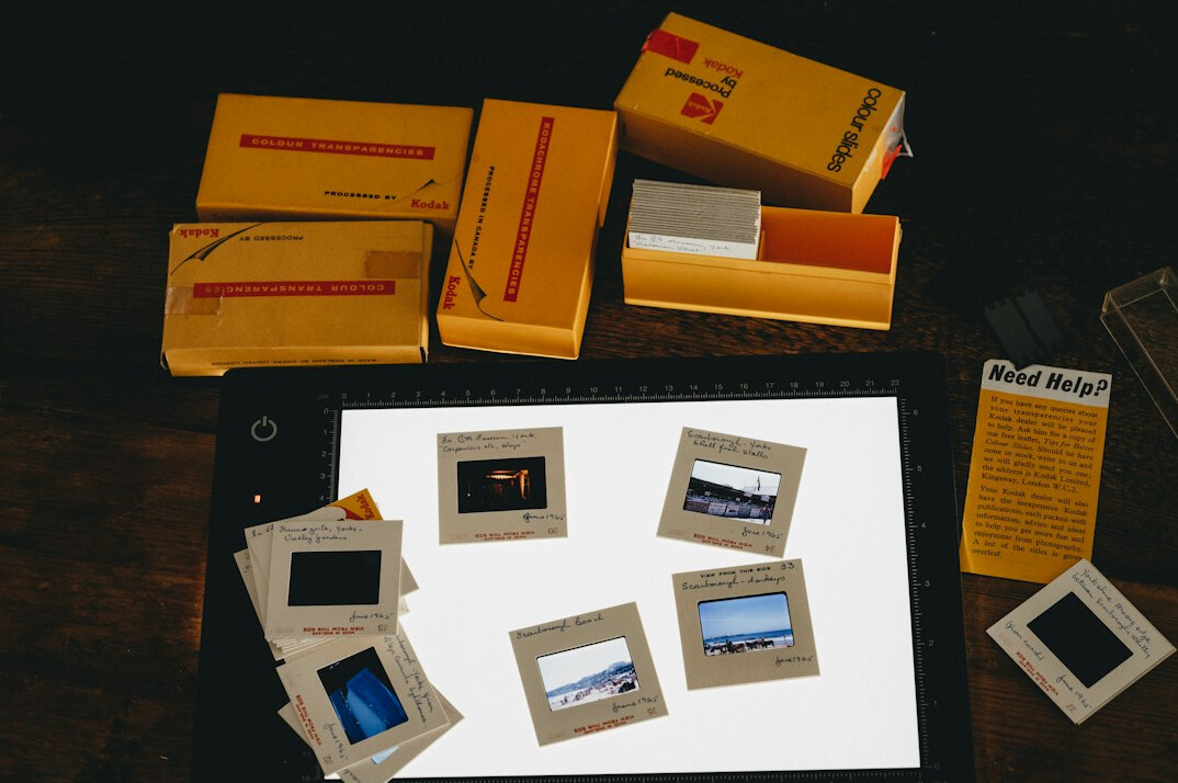 Overhead view of a photographer's desk with printed photo contact sheets