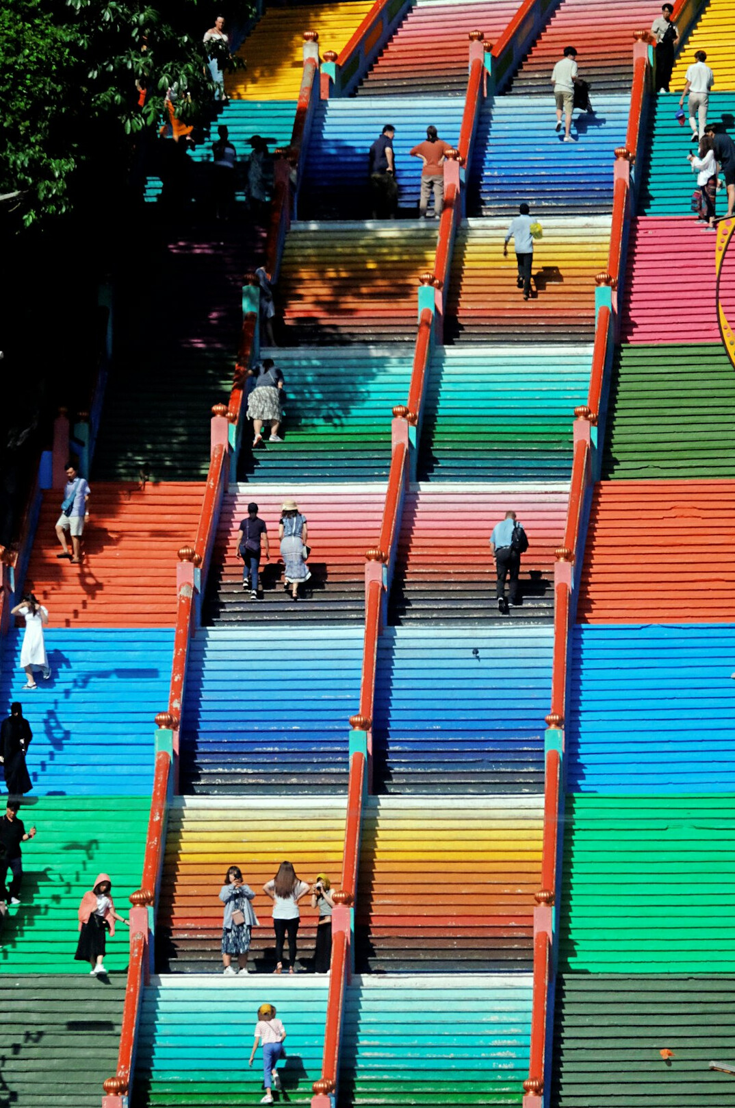 Person walking up a colorful painted staircase in Valparaiso