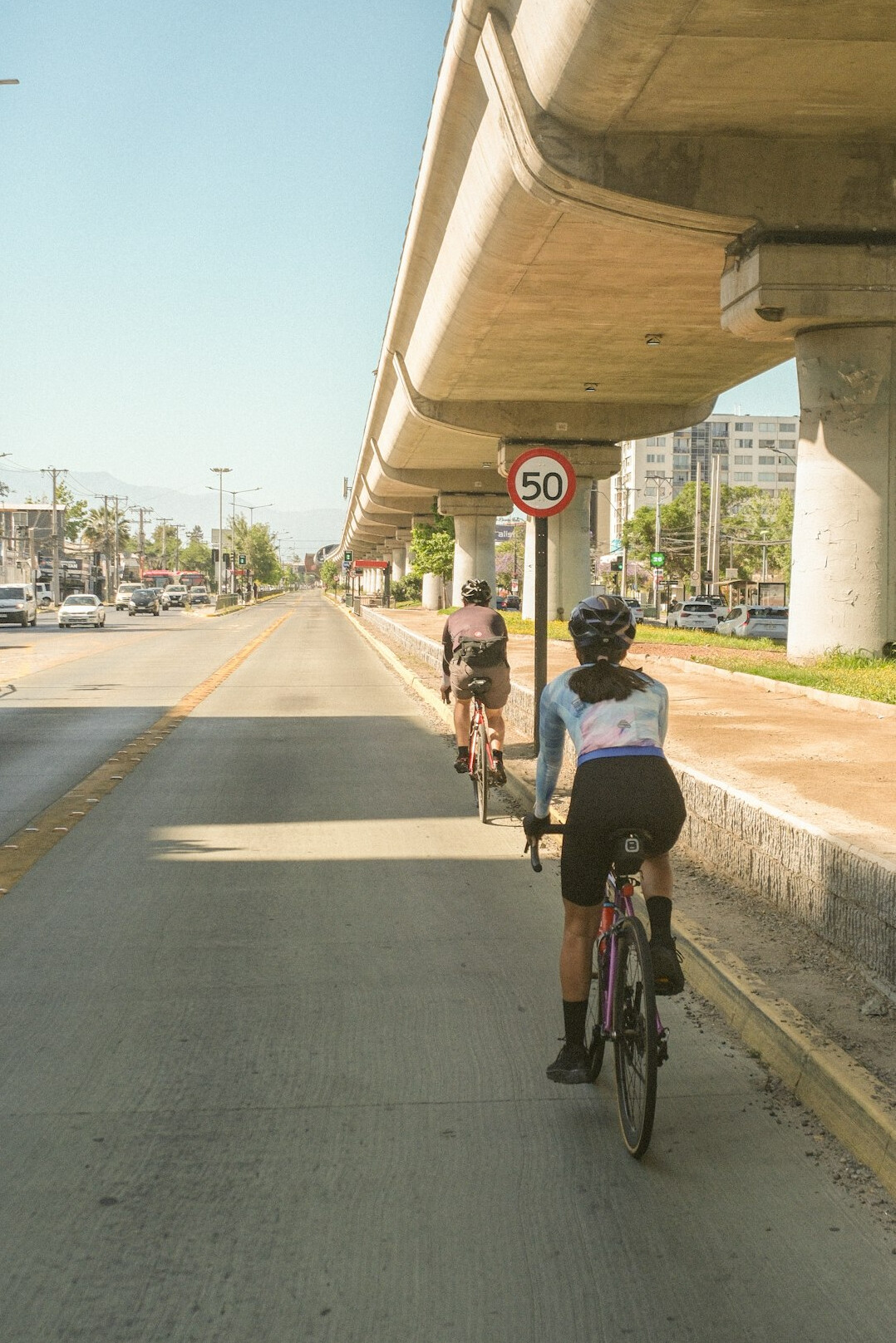 Cyclist commuting through a busy city street in Chile